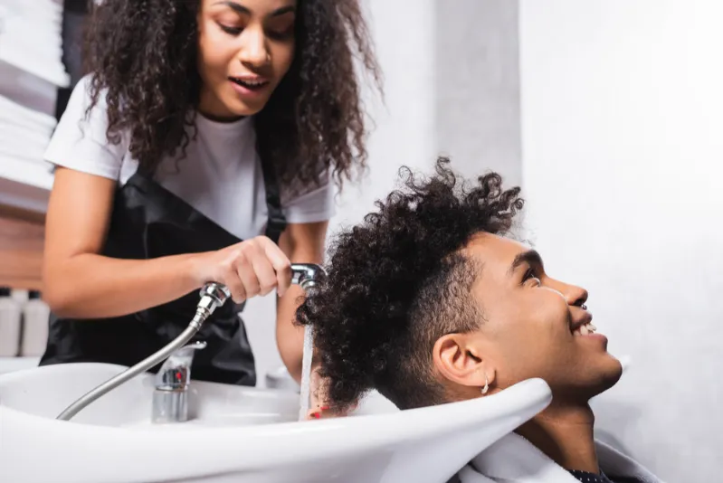 African man getting hair washed