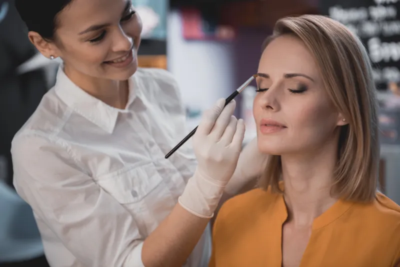 Woman getting makeup applied